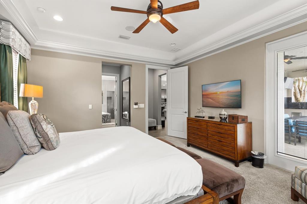 1105 Watson Court Reunion, FL 34747 - Photo 18 of 61 a bedroom with a bed and a flat screen tv