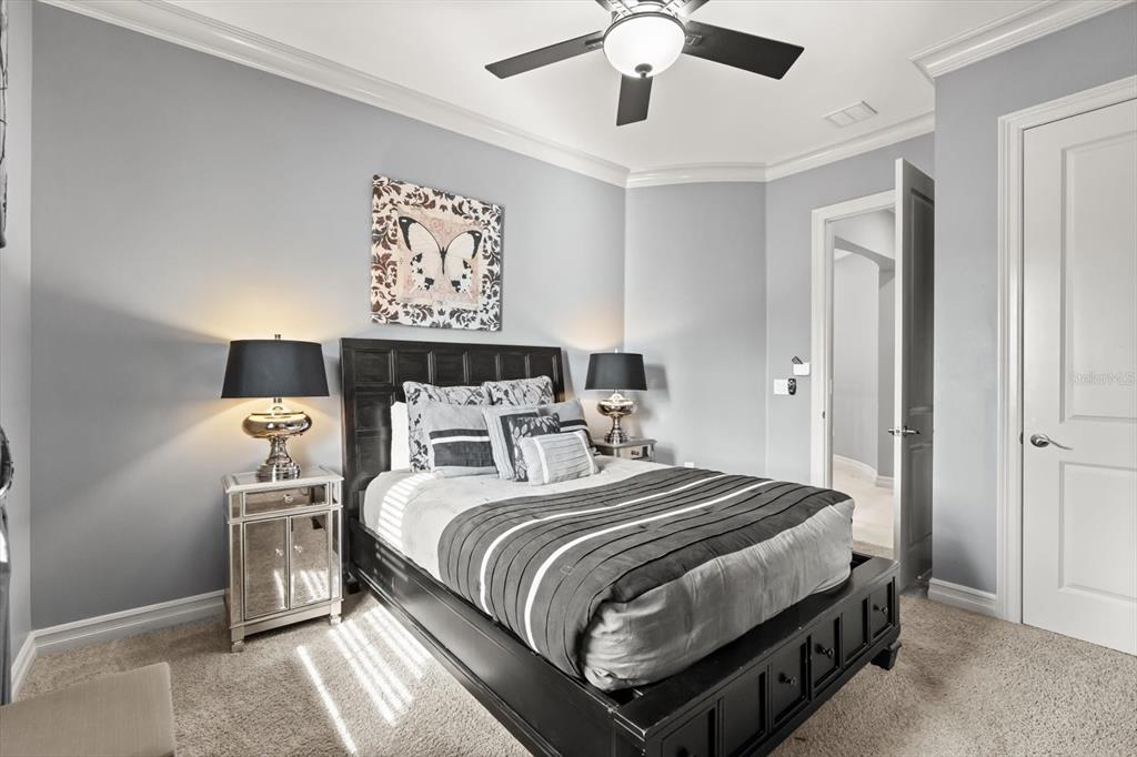 1105 Watson Court Reunion, FL 34747 - Photo 26 of 61 a bedroom with a bed and a chandelier