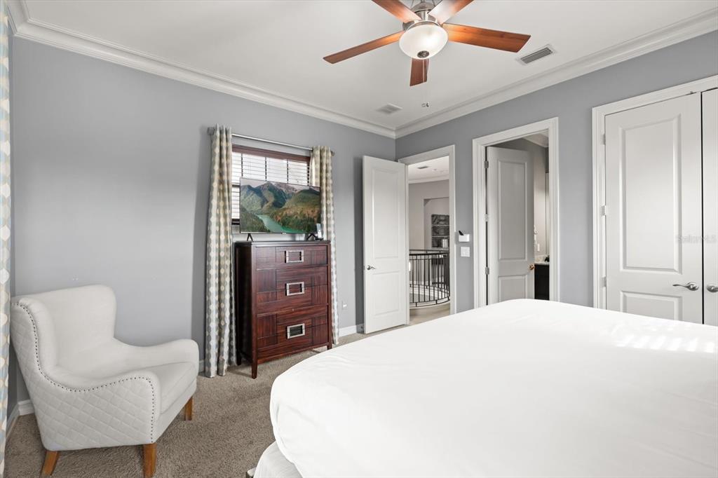 1105 Watson Court Reunion, FL 34747 - Photo 31 of 61 a spacious bedroom with a bed and a couch