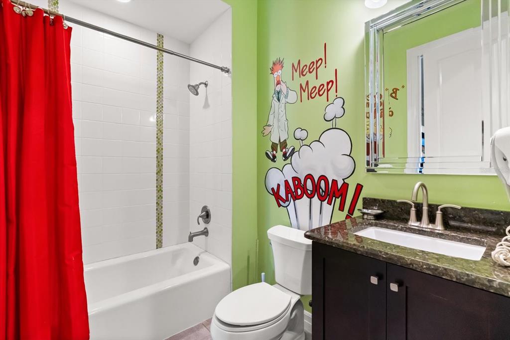 1105 Watson Court Reunion, FL 34747 - Photo 39 of 61 a bathroom with a granite countertop bathtub sink vanity mirror and toilet
