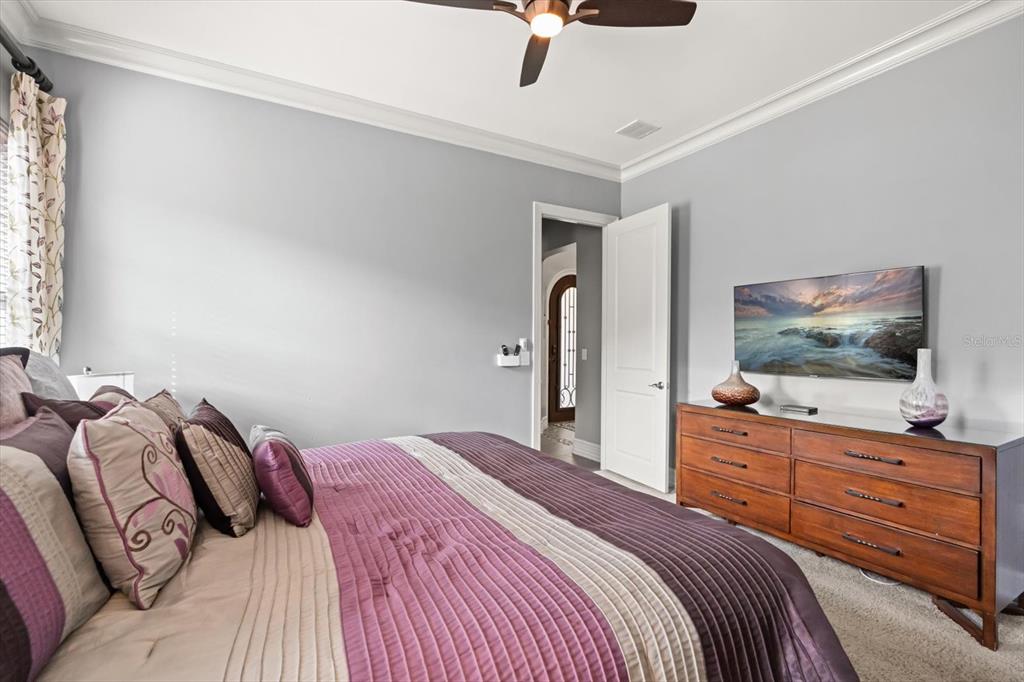 1105 Watson Court Reunion, FL 34747 - Photo 53 of 61 a bedroom with a bed and a flat screen tv