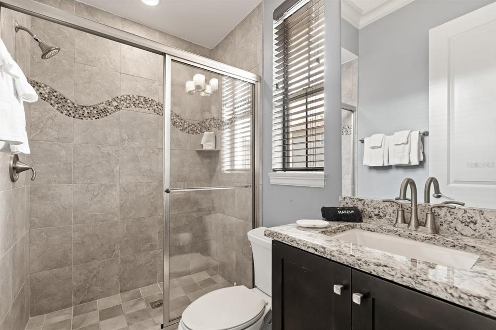 1105 Watson Court Reunion, FL 34747 - Photo 54 of 61 a bathroom with a granite countertop sink toilet and shower