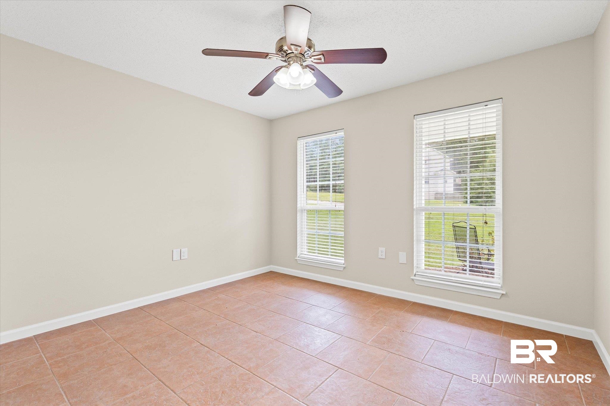 157 Bay View Drive Daphne, AL 36526 - Photo 11 of 22 Spare room with light tile patterned floors, ceiling fan, and a textured ceiling