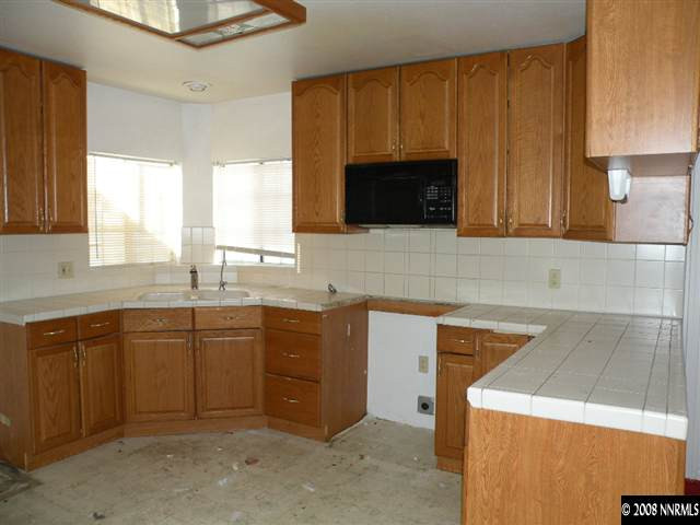 414 Vassar Street Reno, NV 89502 - Photo 2 of 3 a kitchen with sink cabinets and window