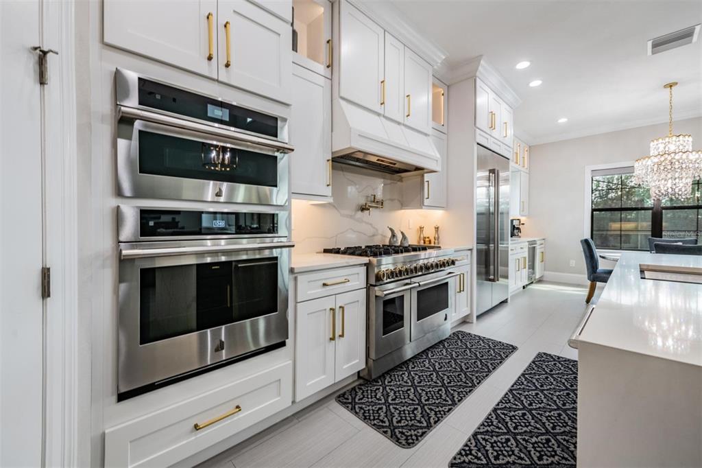 2913 Valencia Ridge Street Valrico, FL 33596 - Photo 14 of 31 a kitchen with stainless steel appliances kitchen island granite countertop a stove and a sink