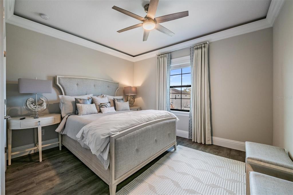 2913 Valencia Ridge Street Valrico, FL 33596 - Photo 22 of 31 a bedroom with a bed and a ceiling fan