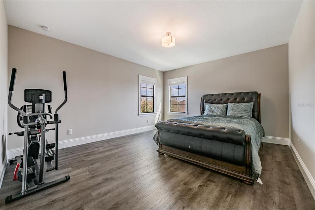 2913 Valencia Ridge Street Valrico, FL 33596 - Photo 23 of 31 a bedroom with a bed and a chandelier