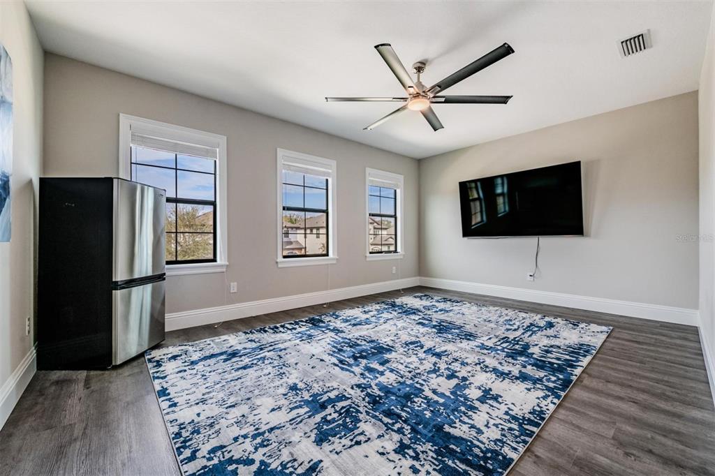 2913 Valencia Ridge Street Valrico, FL 33596 - Photo 25 of 31 a living room with a flat screen tv and a rug