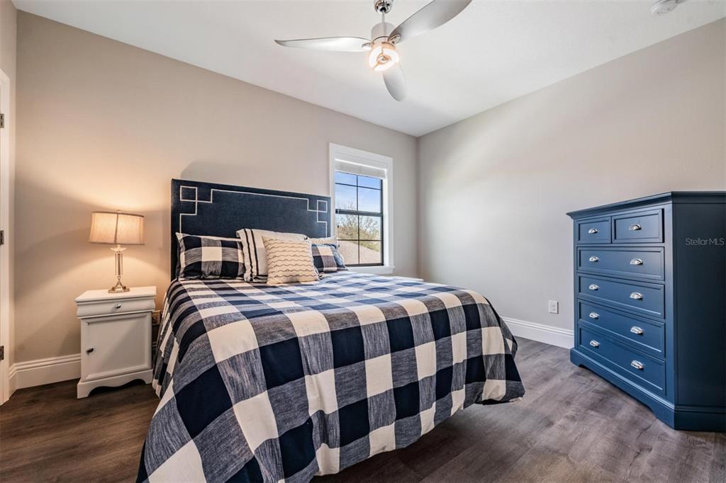 2913 Valencia Ridge Street Valrico, FL 33596 - Photo 26 of 31 a bedroom with a bed and wooden floor