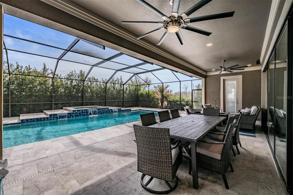 2913 Valencia Ridge Street Valrico, FL 33596 - Photo 27 of 31 a view of a patio with a table chairs and a backyard
