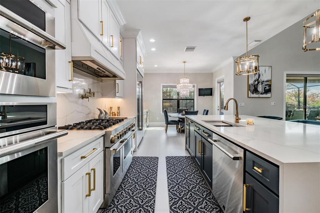 2913 Valencia Ridge Street Valrico, FL 33596 - Photo 3 of 31 a large kitchen with stainless steel appliances granite countertop a stove and a sink