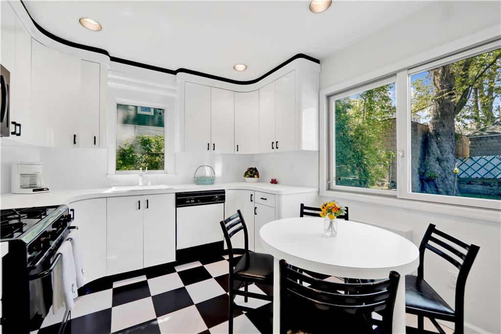 188 79th Street Brooklyn, NY 11209 - Photo 14 of 30 a kitchen with a sink a stove a dining table and chairs