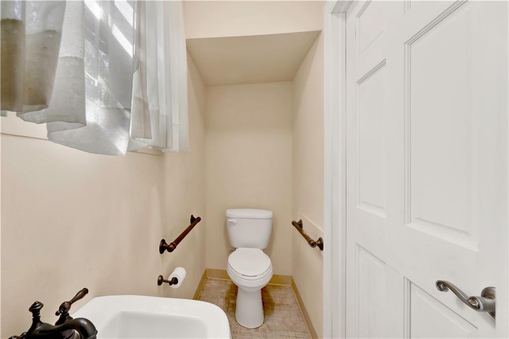 188 79th Street Brooklyn, NY 11209 - Photo 17 of 30 a bathroom with a toilet a sink and mirror