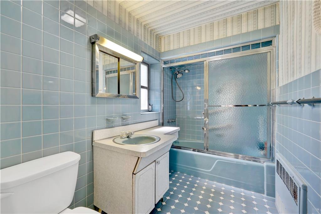 188 79th Street Brooklyn, NY 11209 - Photo 22 of 30 a bathroom with a sink a toilet and shower