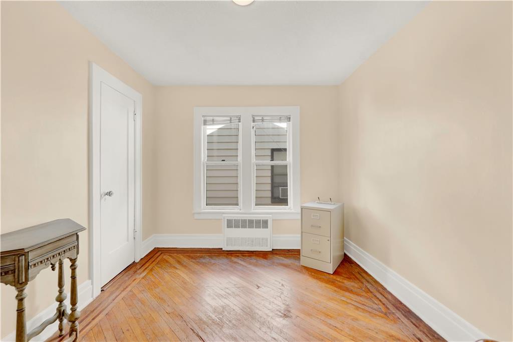188 79th Street Brooklyn, NY 11209 - Photo 24 of 30 a view of an empty room with wooden floor and a window