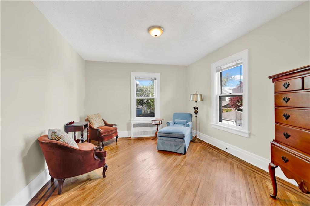 188 79th Street Brooklyn, NY 11209 - Photo 25 of 30 a living room with furniture and a wooden floor