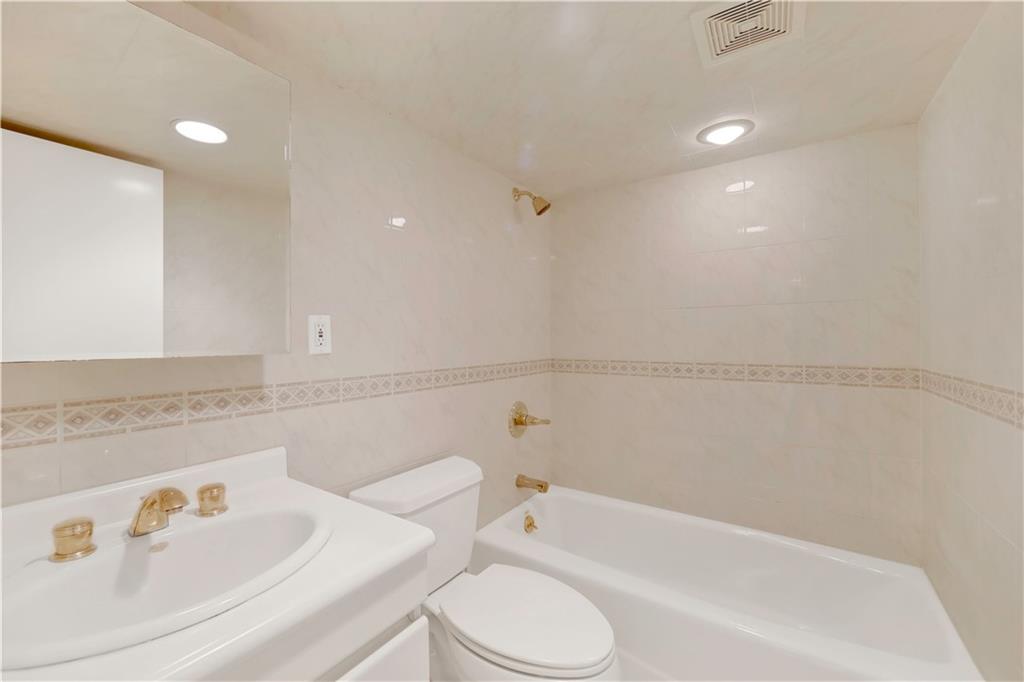 188 79th Street Brooklyn, NY 11209 - Photo 29 of 30 a bathroom with a bathtub and sink