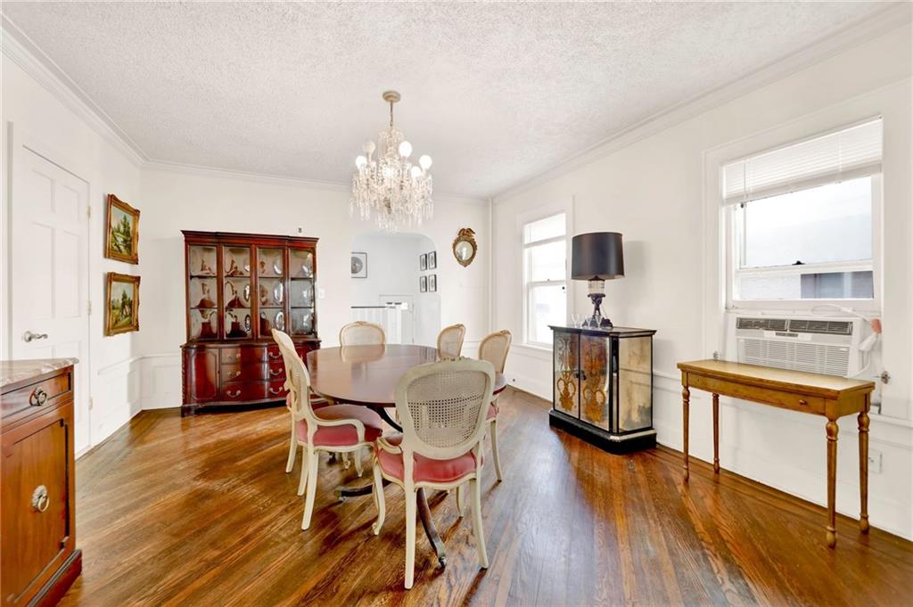 188 79th Street Brooklyn, NY 11209 - Photo 10 of 30 a view of a dining room with furniture a chandelier and wooden floor