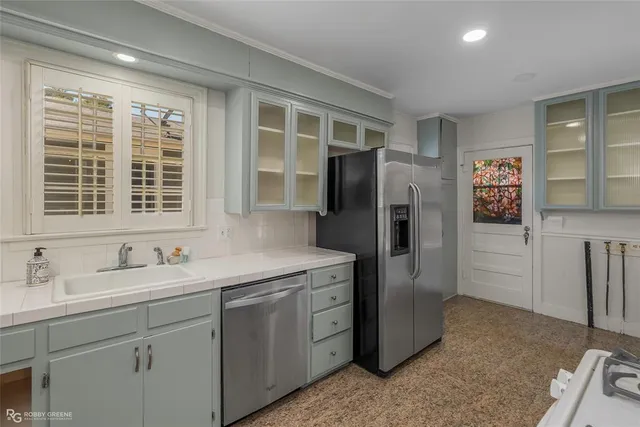 a kitchen with stainless steel appliances granite countertop a refrigerator and a sink