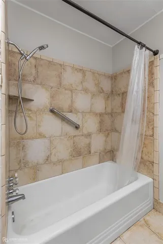 a bathroom with a shower and a bath tub