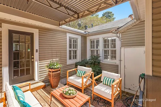 a view of a patio with couches chairs and potted plants