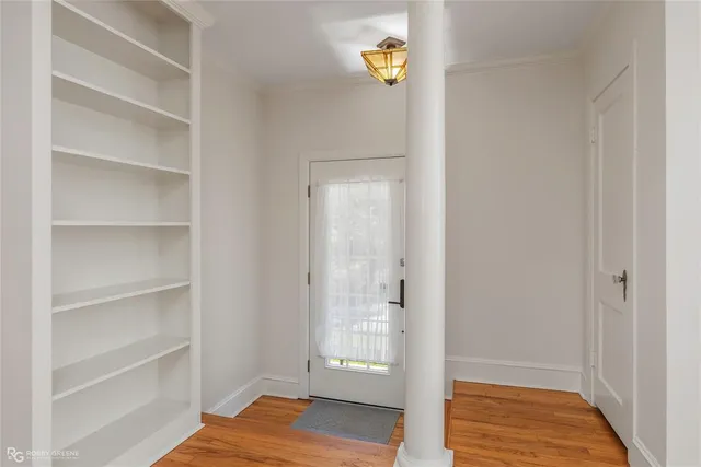 a view of a bedroom with wooden floor and closet