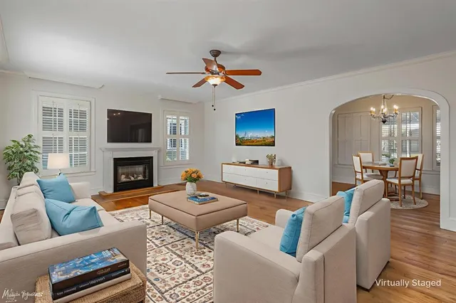 a living room with furniture a fireplace and a flat screen tv