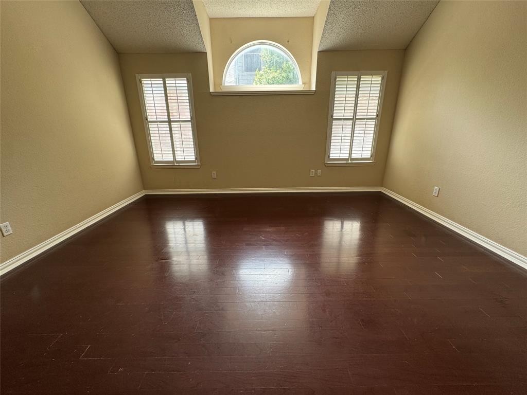 8272 Beartooth Drive Frisco, TX 75036 - Photo 11 of 16 an empty room with wooden floor and windows