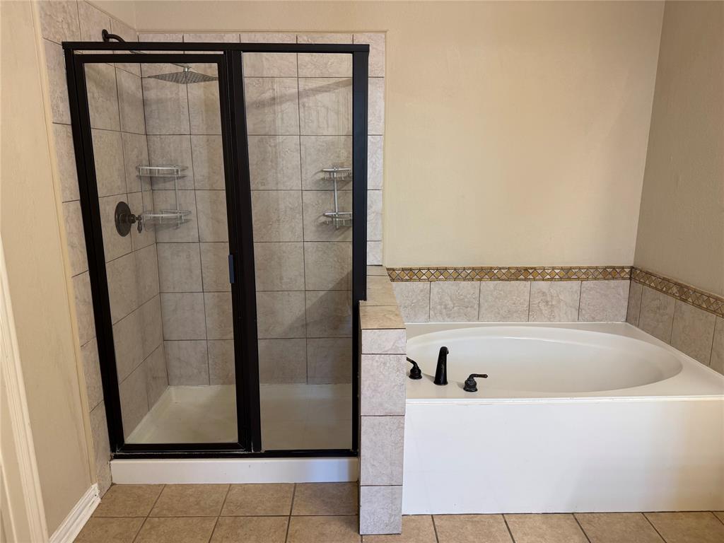8272 Beartooth Drive Frisco, TX 75036 - Photo 12 of 16 a bathroom with a bathtub and shower