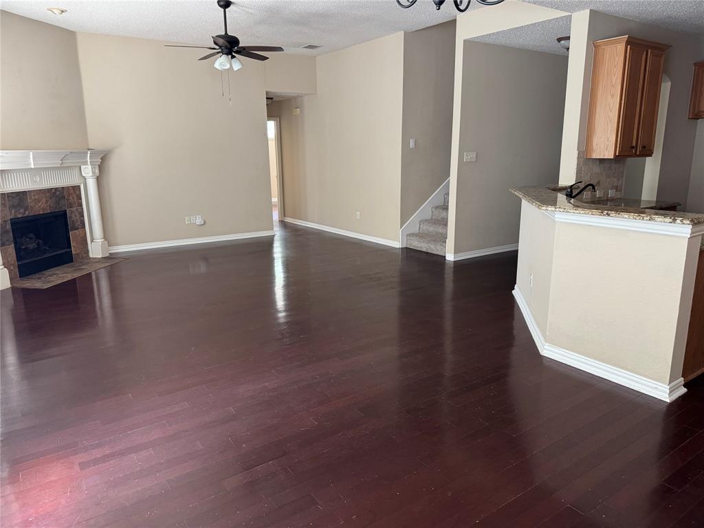 8272 Beartooth Drive Frisco, TX 75036 - Photo 9 of 16 wooden floor in an empty room with a fireplace