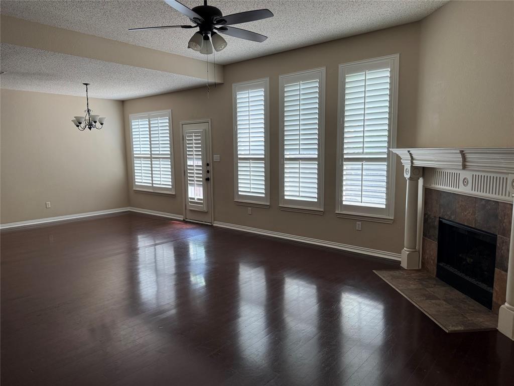 8272 Beartooth Drive Frisco, TX 75036 - Photo 10 of 16 a view of an empty room with wooden floor fireplace and a window