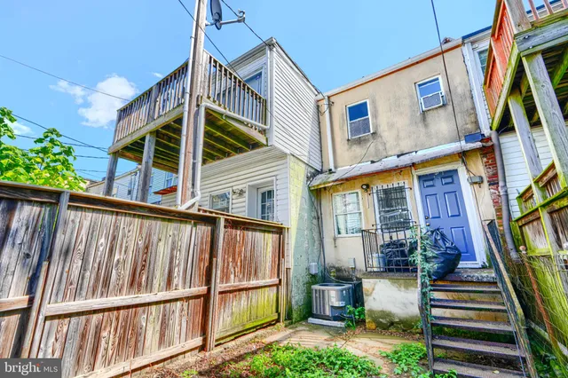 a view of a porch with a floor to ceiling window and tree