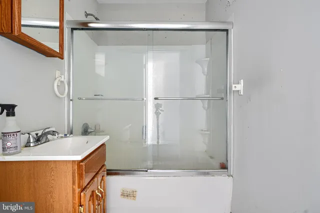 a bathroom with a sink mirror toilet and bathtub