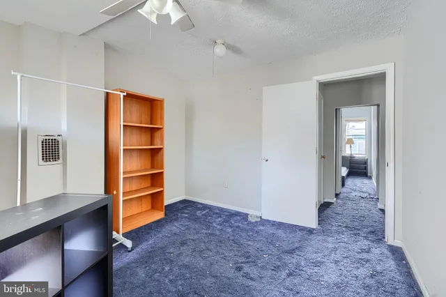 a view of a livingroom with furniture and closet