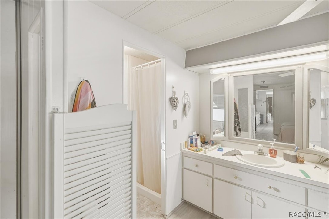928 South Shad Terrace Inverness, FL 34450 - Photo 20 of 48 a bathroom with a double vanity sink and a mirror