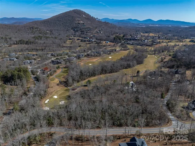 an aerial view of residential house and sandy dunes