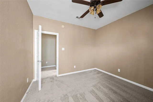 a spacious bathroom with a tub shower and windows
