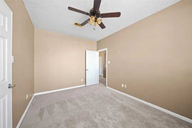 a view of a chandelier in big room and chandelier fan