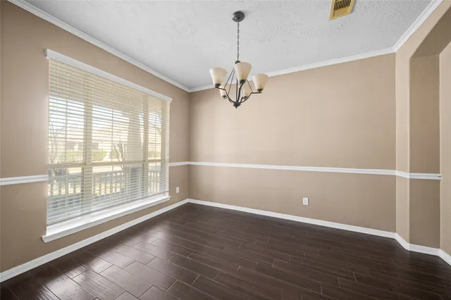 a view of a livingroom with wooden floor and a window