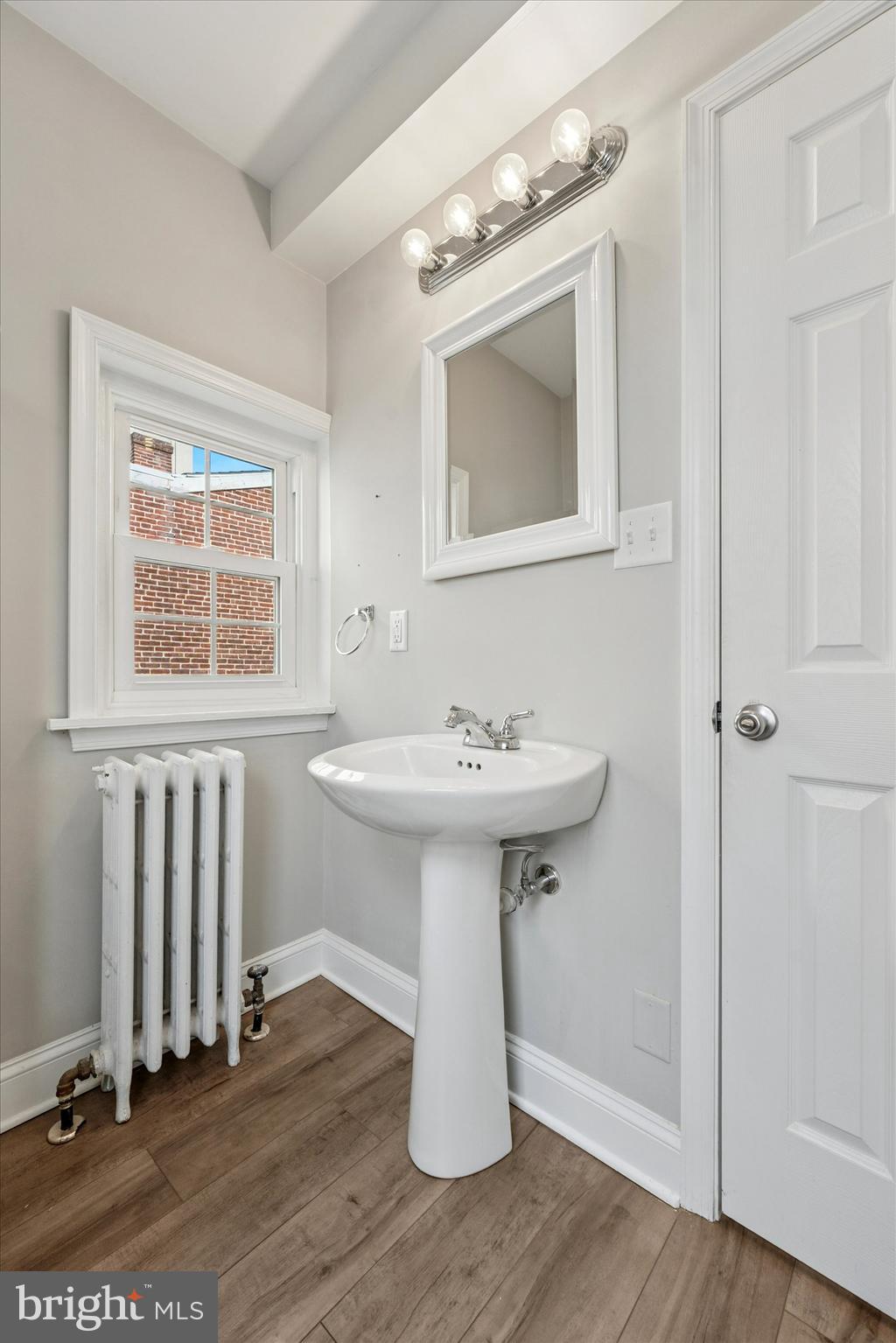 19 South New Street, Unit 2 West Chester, PA 19382 - Photo 12 of 20 a bathroom with a sink a mirror and shower