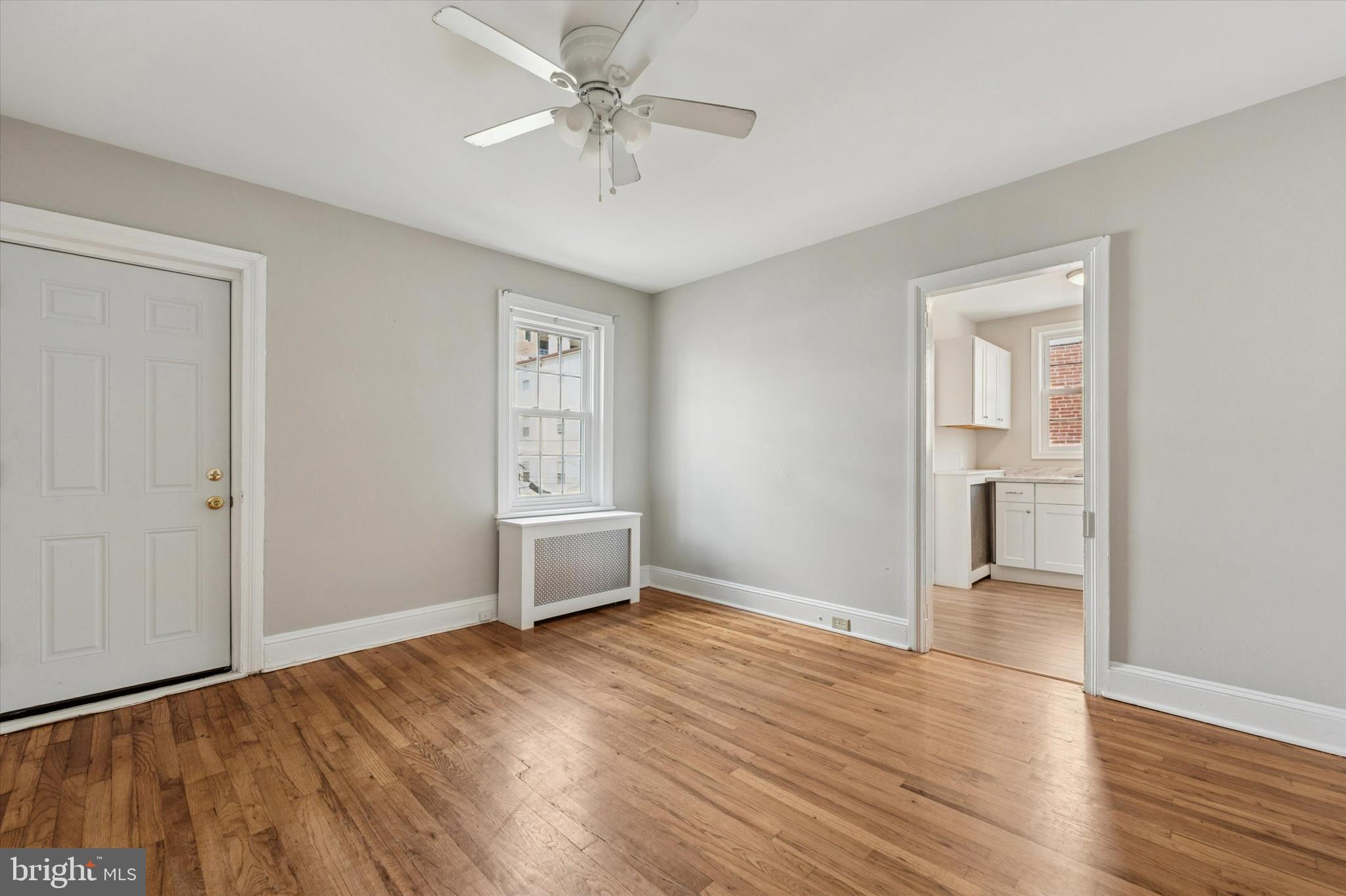 19 South New Street, Unit 2 West Chester, PA 19382 - Photo 19 of 20 wooden floor in an empty room with a window