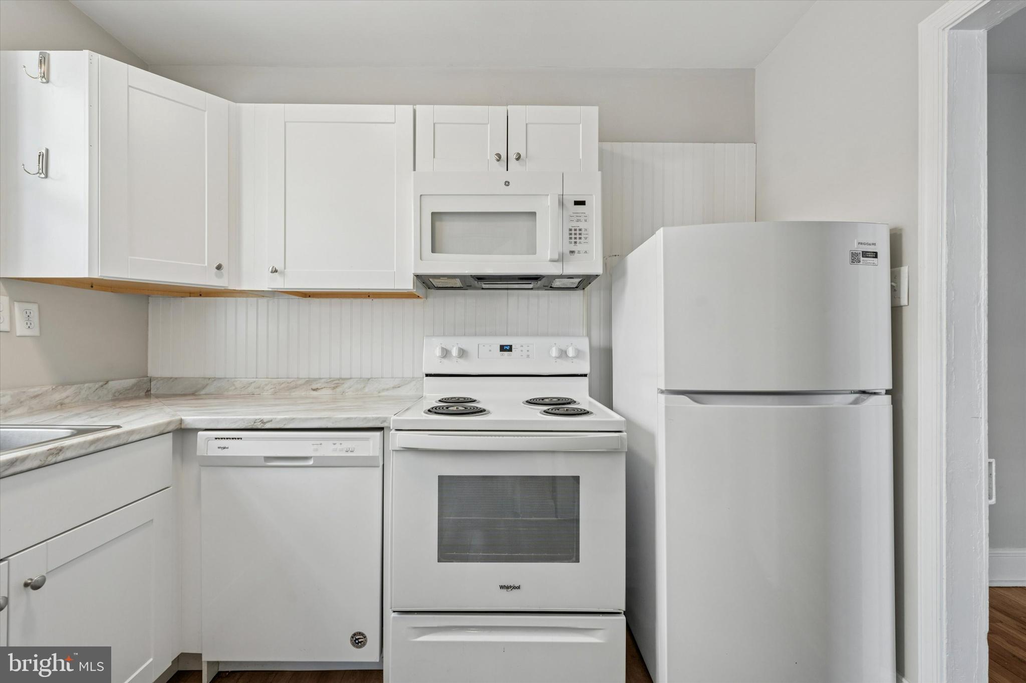 19 South New Street, Unit 2 West Chester, PA 19382 - Photo 8 of 20 a white refrigerator freezer sitting in a kitchen