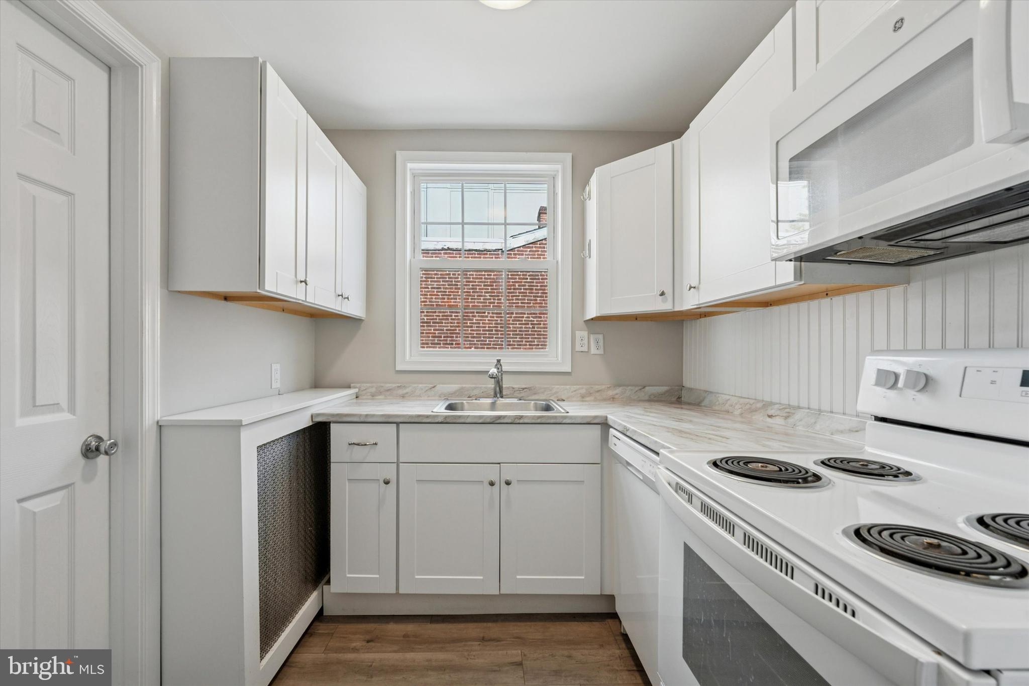 19 South New Street, Unit 2 West Chester, PA 19382 - Photo 9 of 20 a kitchen with a sink stove top oven and cabinets