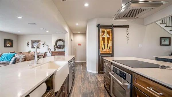 a kitchen with counter top space a sink and wooden floor