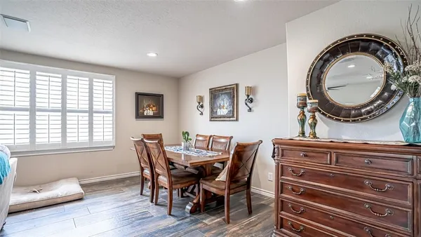 a dining room with furniture and window