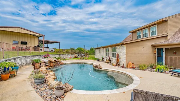 a view of a house with pool porch and furniture
