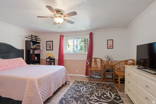 553 North 200 West Bountiful, UT 84010 - Photo 12 of 26 Bedroom featuring light wood-type flooring, ornamental molding, ceiling fan, and a textured ceiling