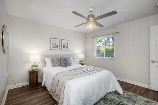 a bedroom with a large bed and a window