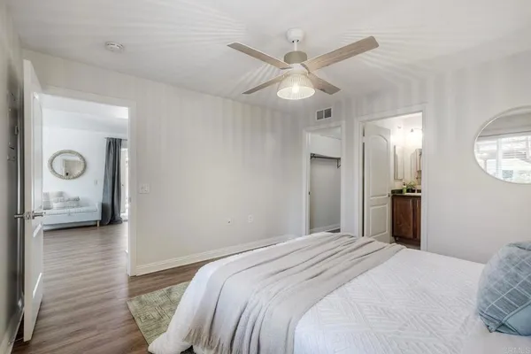 a bedroom with a large bed and a chandelier