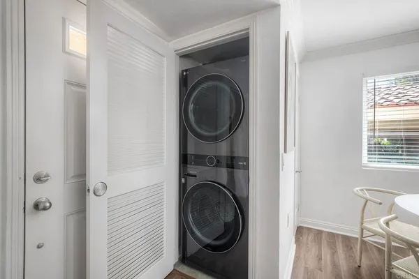 a utility room with dryer washer and a window